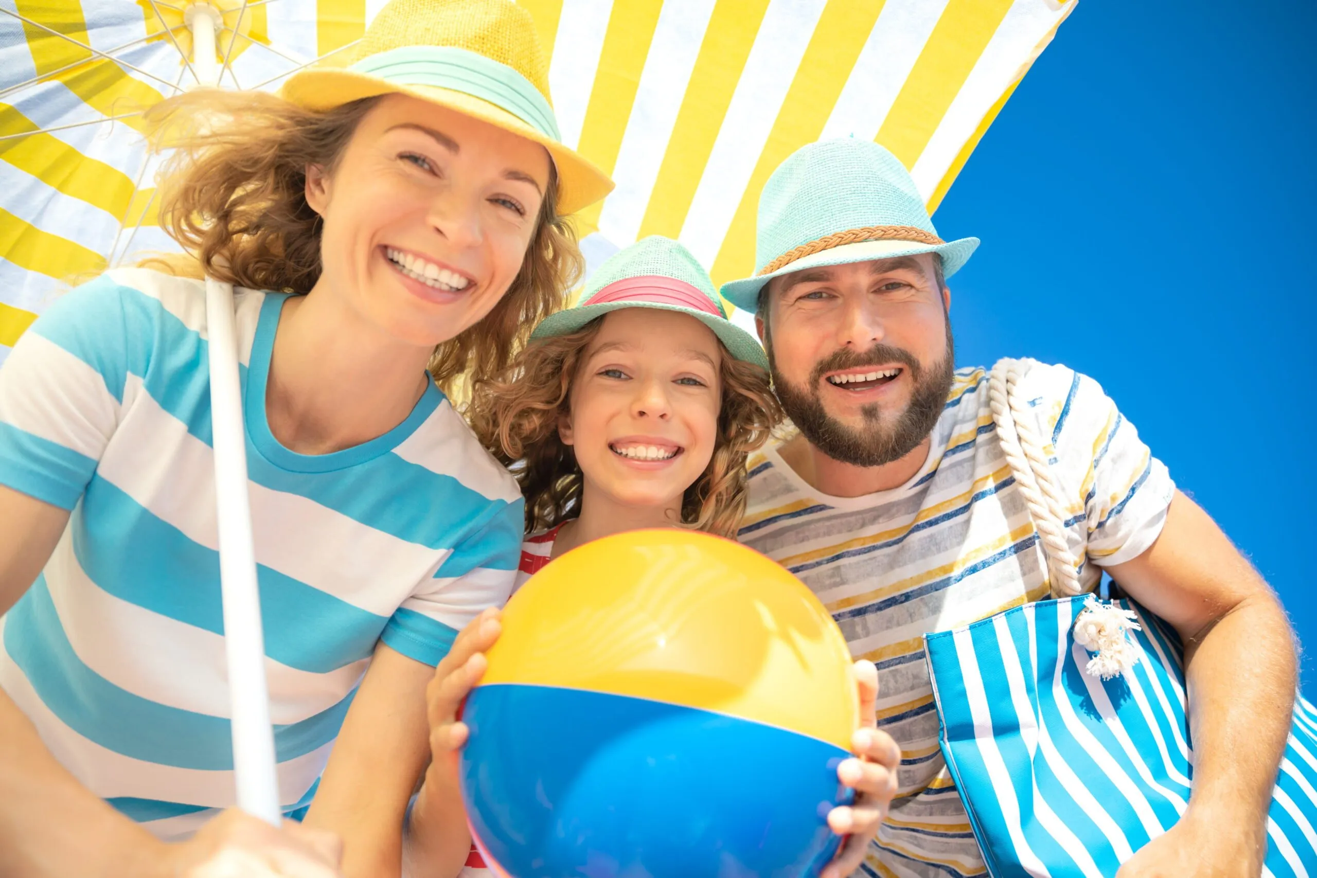 Family enjoying summer vacation while keeping smiles healthy