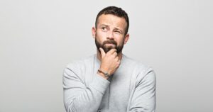 A man wondering about the cost of a dental crown