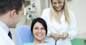 A woman sitting in dental chair after gettting composite fillings