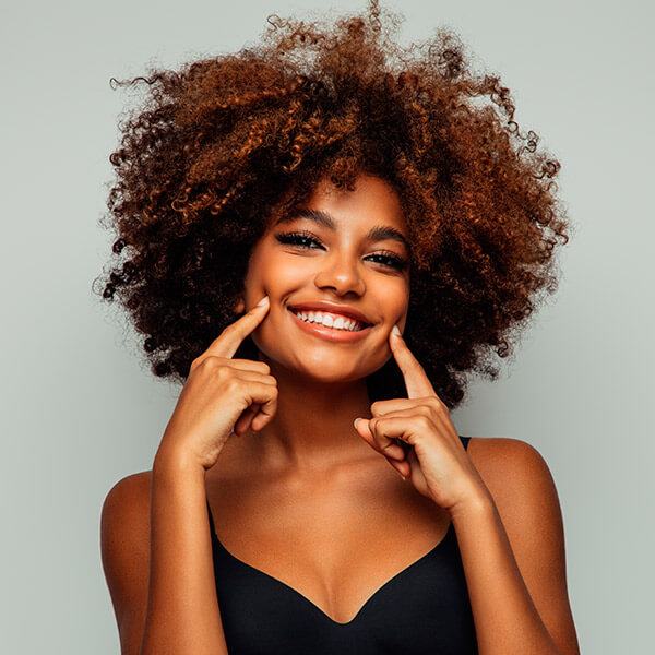 Young woman with curly hair smiling