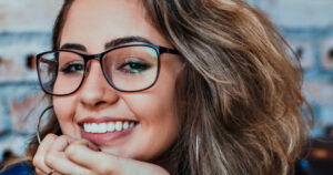 Woman in glasses smiling brightly