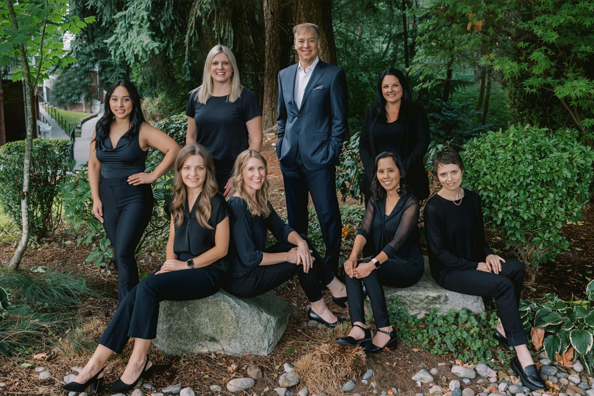 Our staff members smiling in the forest