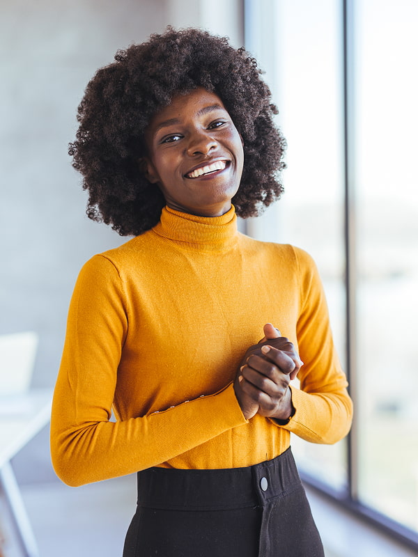 Woman in a yellow sweater smiling