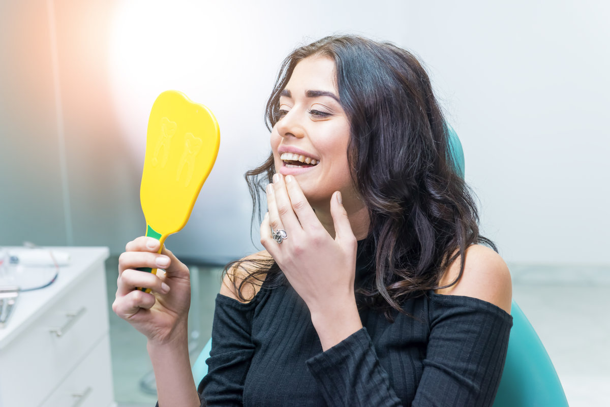 A young woman smiling with her metal-free fillings