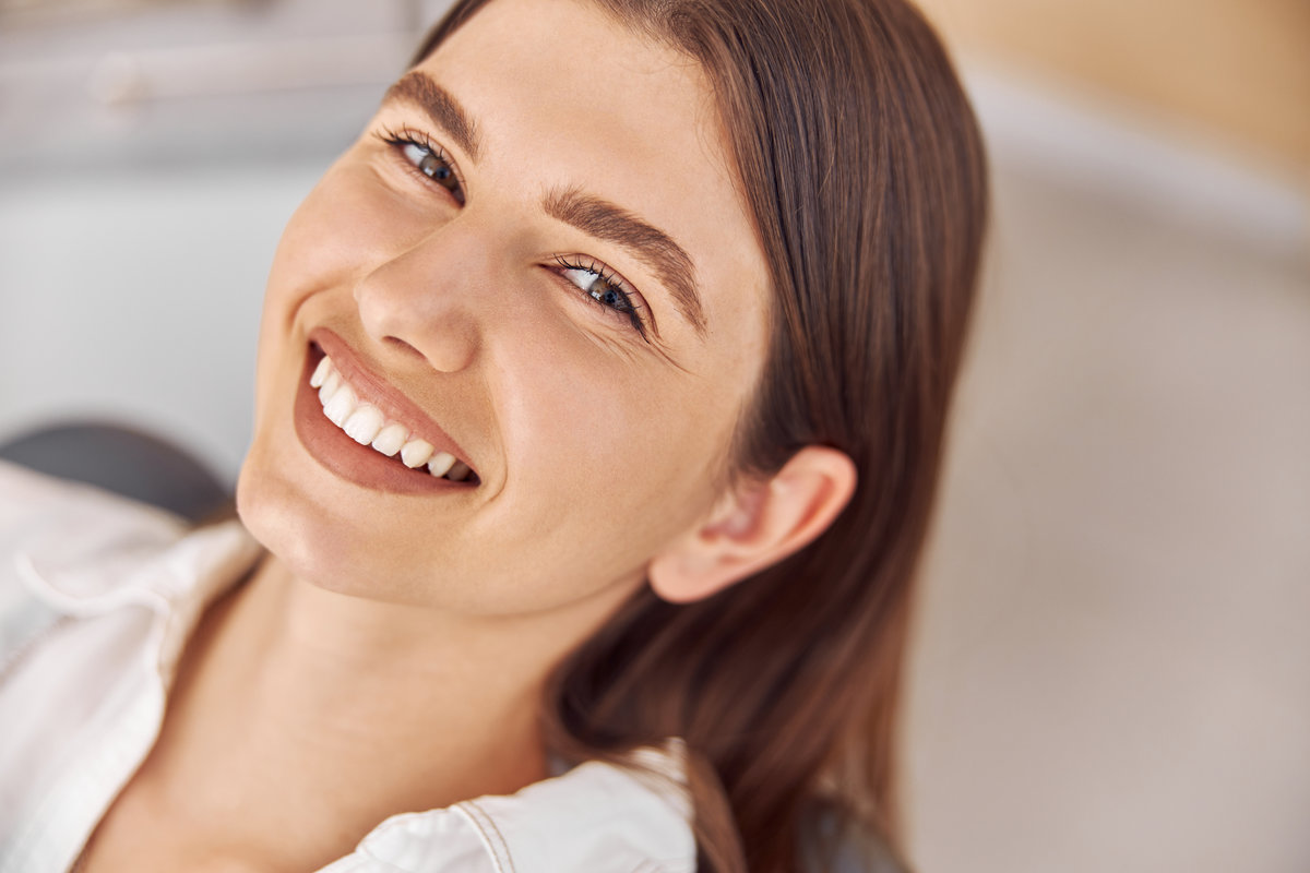 A young woman smiling with her metal-free fillings