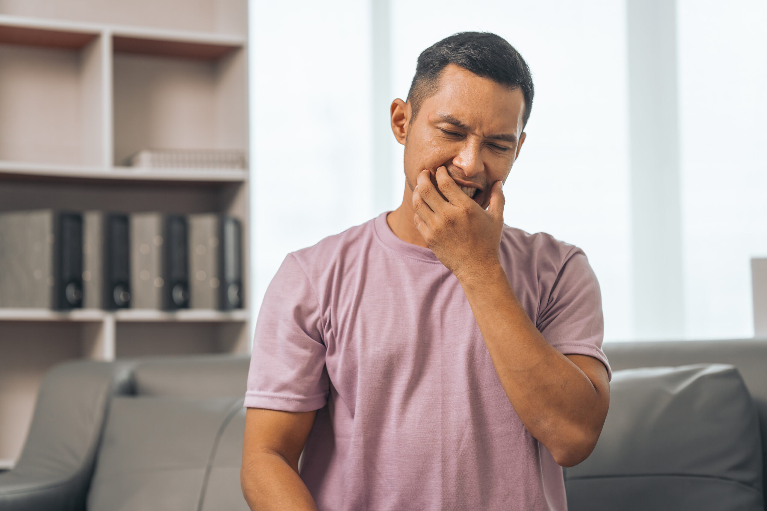 A mature man in the dentist's office waiting for his dental exam while smiling