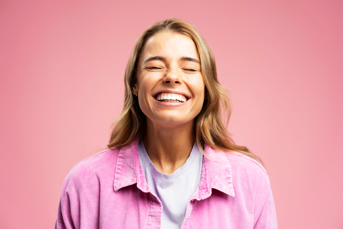 A young woman smiling with her metal-free fillings