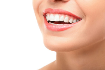 Woman smiling with bright white teeth after porcelain veneers