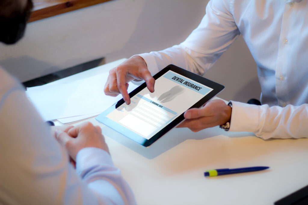 Insurance agent explaining dental insurance coverage to a patient